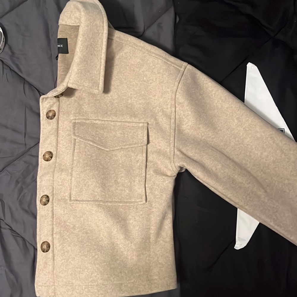 Really cute short jacket. Medium weight.